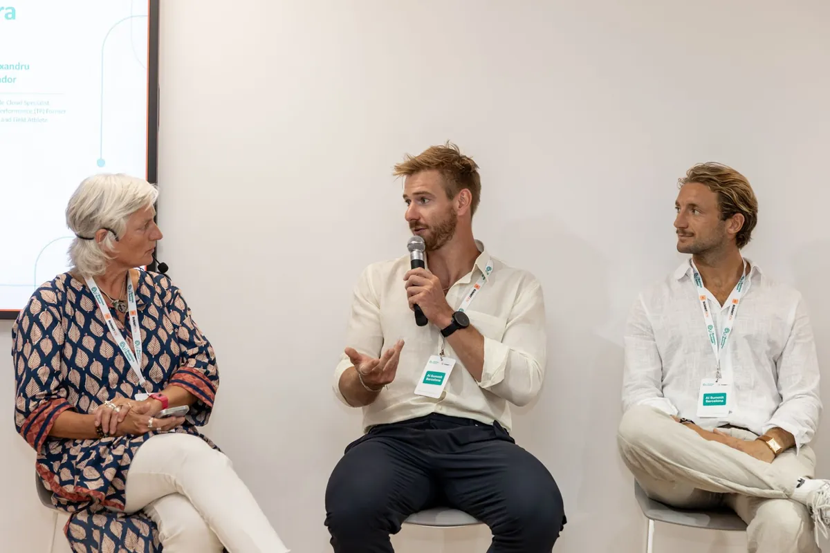 Barnabé Delarze speaking on a panel, seated between two other speakers